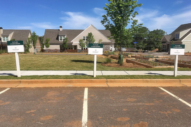 a sign in front of a parking lot