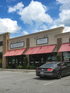 a black car parked in front of a store