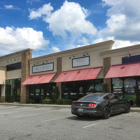 a black car parked in front of a store