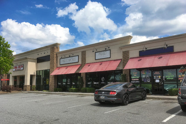a black car parked in front of a store