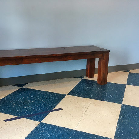 a wooden bench in a room
