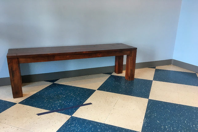 a wooden bench in a room