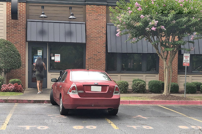 a red car parked in front of a building
