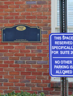 a sign next to a brick building