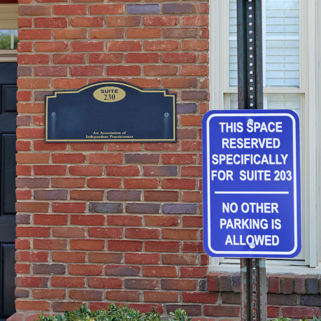a sign next to a brick building