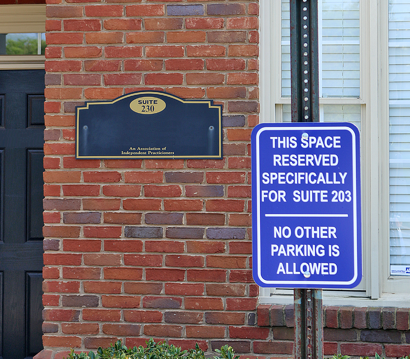 a sign next to a brick building