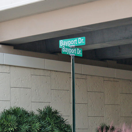 a street sign under a bridge