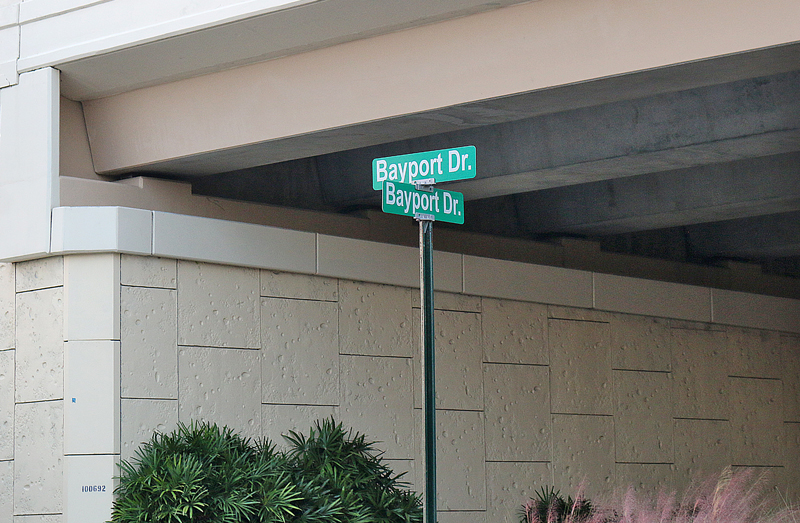a street sign under a bridge