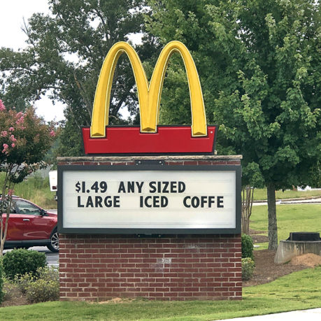 a sign on a brick wall