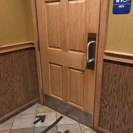 a wooden door with a metal handle