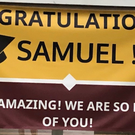 a yellow and red sign with black text