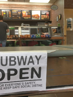 a sign on a counter in a subway restaurant
