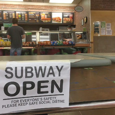 a sign on a counter in a subway restaurant