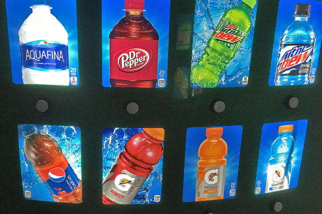 a group of soda bottles on a wall