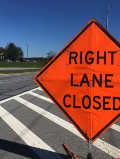 an orange sign on a street