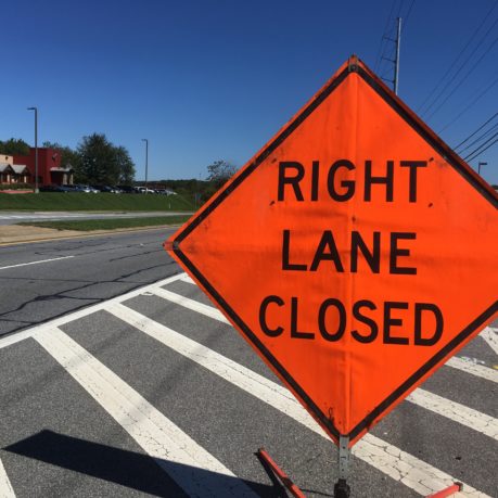 an orange sign on a street