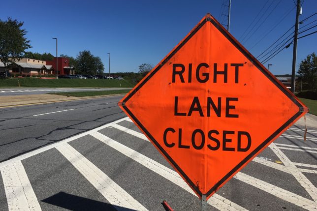 an orange sign on a street