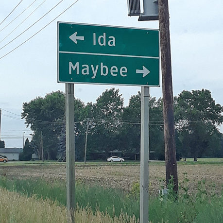 a street sign with an arrow pointing to an address