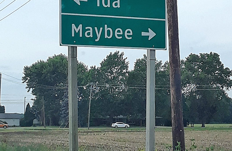 a street sign with an arrow pointing to an address