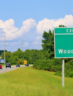a green exit sign on a highway