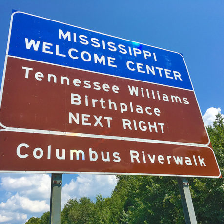 a sign with white text and blue text