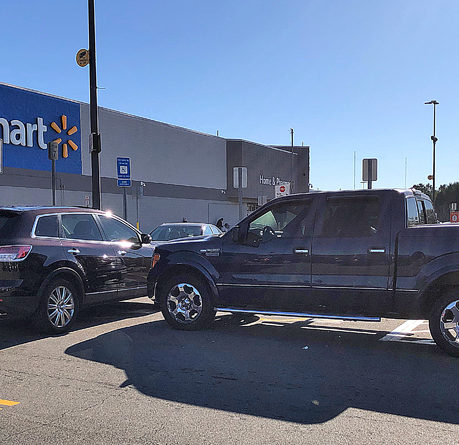a black truck parked in a parking lot