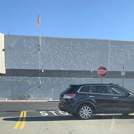 a black car parked in front of a building