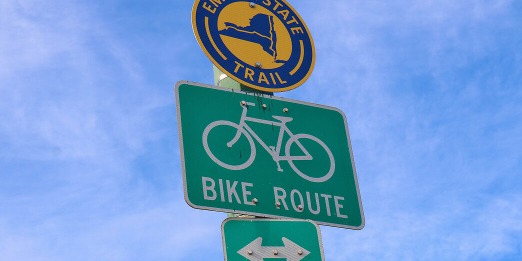 a green and white sign on a pole