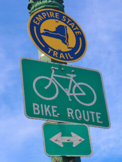 a green and white sign on a pole