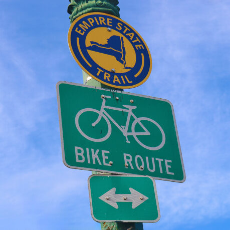 a green and white sign on a pole