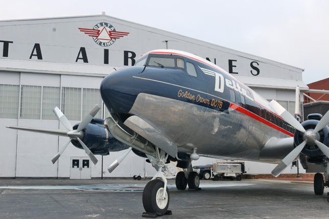 a plane parked in front of a building