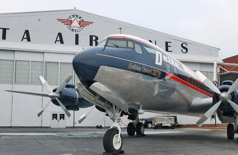 a plane parked in front of a building