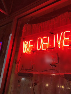 a red neon sign on a window