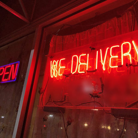 a red neon sign on a window