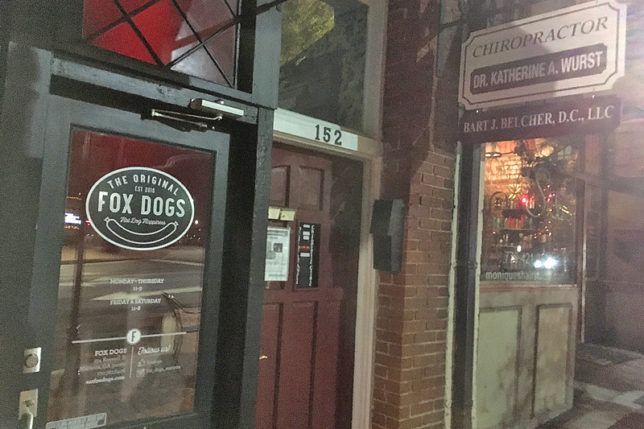 a store front with a sign on the door