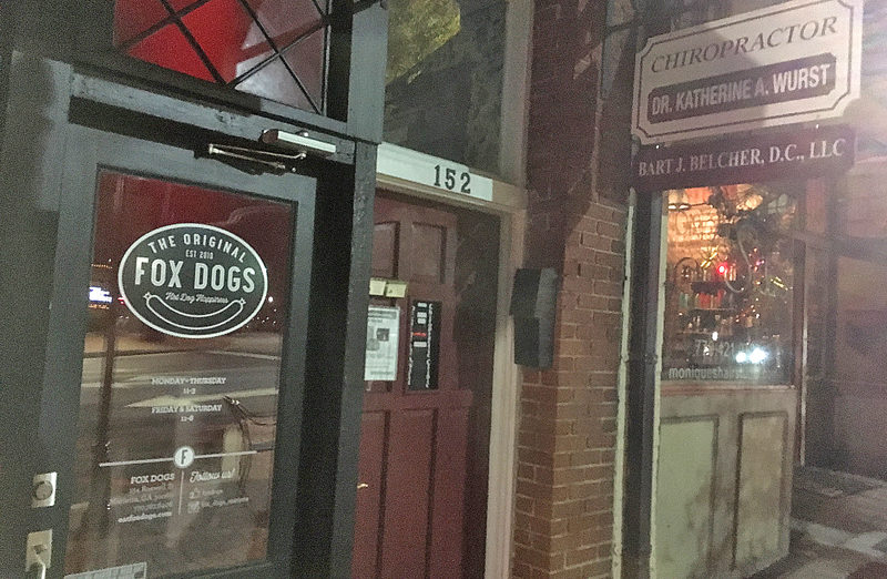 a store front with a sign on the door