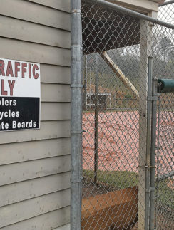 a fenced in area with a sign