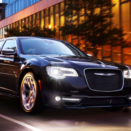 a black car driving on a street