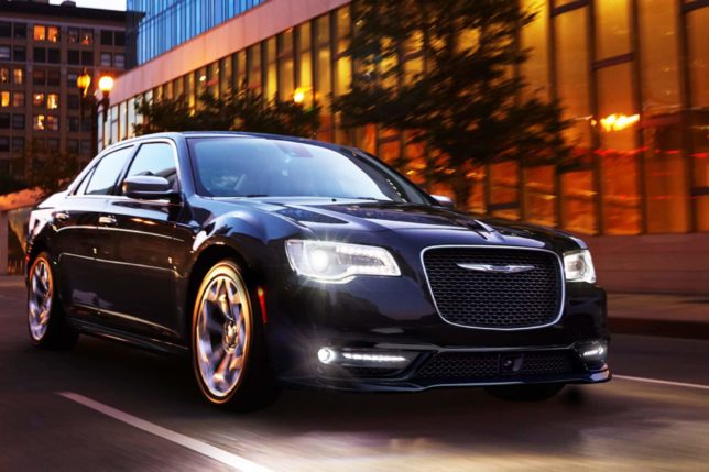 a black car driving on a street