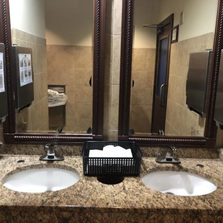 a bathroom with sinks and mirrors