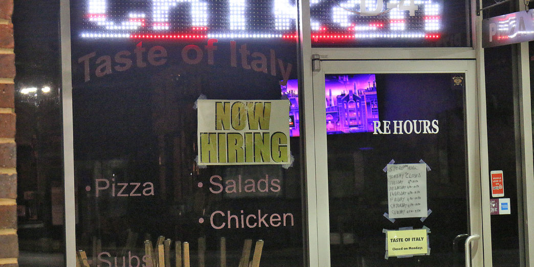 a restaurant with signs on the glass door
