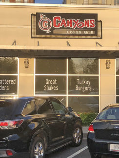 cars parked in front of a restaurant