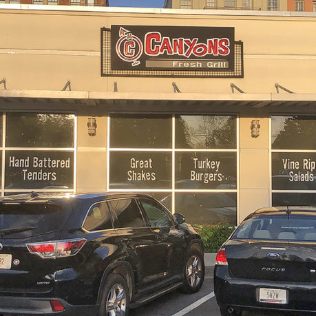 cars parked in front of a restaurant