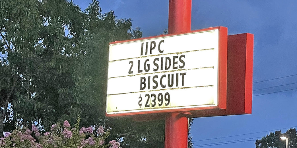 a sign on a red pole