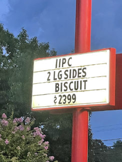 a sign on a red pole