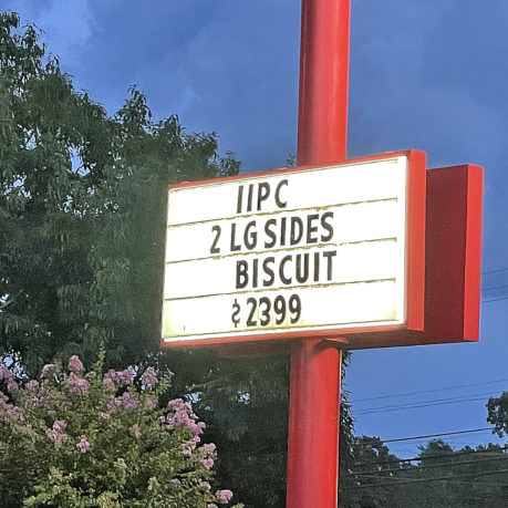 a sign on a red pole