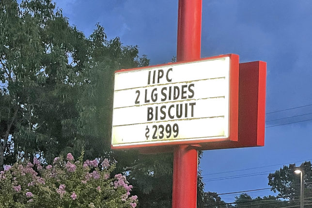 a sign on a red pole