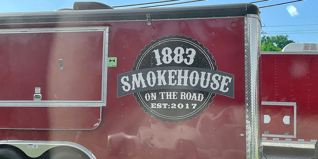 a red food truck with white text on the side