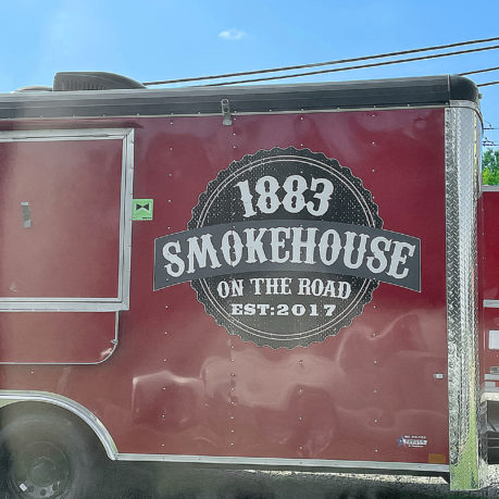 a red food truck with white text on the side