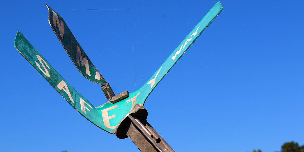 a green sign with white text on it